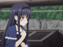a girl with long black hair is wearing a blue top