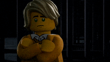a lego man with his arms crossed is standing in front of a prison cell