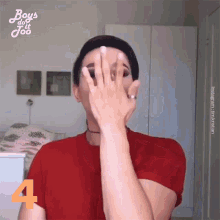 a woman in a red shirt covering her face with her hands and the number 4 behind her