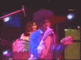 a man with an afro singing into a microphone on stage