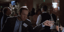 a man in a suit has a name tag that says " g " on it