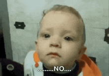 a baby is making a face and saying no .