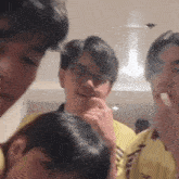 a group of young men are standing next to each other in a room eating food .