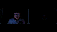 a man with glasses and headphones is sitting next to another man with glasses and headphones