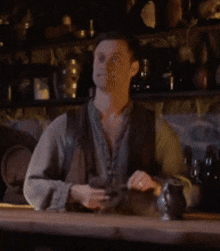 a man sits at a table in a dark room