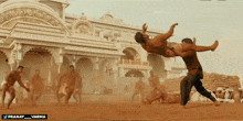 a man is being lifted in the air by another man with the words pranay_varma below him