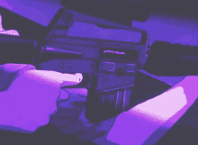 a person is holding a gun in their hands in a dark room .