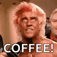 a man with a mohawk is holding a microphone and says `` coffee ! ''
