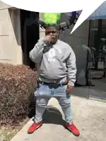 a man wearing a gray sweatshirt that says rolling ape on it