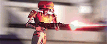a robot with a helmet is holding a gun and shooting it .