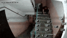 a video of a person walking down a set of stairs has the date 12-13-2016 at the top