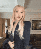 a woman with blonde hair wearing a black jacket