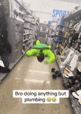 a man in a green hulk costume is doing a handstand in a store