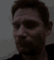 a man with a beard is looking at the camera