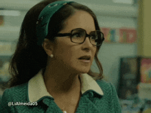 a woman wearing glasses and a green headband has the hashtag lialmeida05 at the bottom