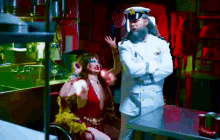 a man in a military uniform is talking to a woman in a red dress
