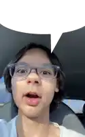 a young girl wearing glasses is making a funny face with a speech bubble above her head