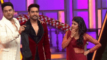 a man in a red suit is standing next to a woman in a red dress .