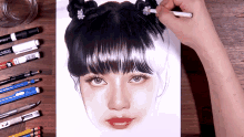 a person is drawing a girl 's face with a marker that says crayola
