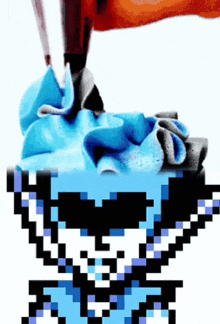 a pixel art of a cupcake with blue frosting on top