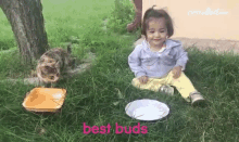 a little girl is sitting in the grass next to a cat and a bowl of milk with the words best buds above her