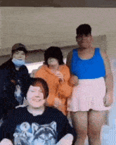 a group of young people are standing next to each other and smiling .