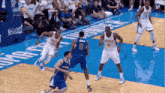a group of basketball players on a court with the number 6 on the back of their jersey