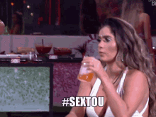 a woman holding a drink with the hashtag #sextou written below her