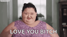 a very fat woman is saying `` love you bitch '' while wearing a purple dress .