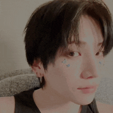 a close up of a person 's face with butterflies on their face