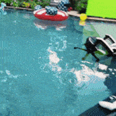 a swimming pool with a red white and blue life preserver