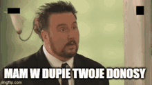 a man in a suit and tie says mam w dupie twoje donosy in a foreign language