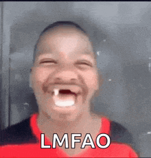 a man with a tooth in his mouth is making a funny face with the word lmfao .