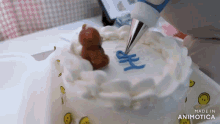 a person is decorating a cake with blue frosting