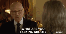 a man in a suit and tie is talking to a woman in a netflix advertisement