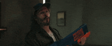 a man is holding a psycho hybrid toy