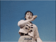 a woman in a white jacket is holding up her fist and says five pink