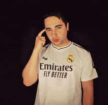 a man wearing a emirates fly better shirt