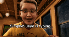 a boy wearing glasses and a yellow shirt with the words simplyblueeye is typing