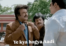 a man with a mustache talks to two other men with ye kya hogya aadi written below them