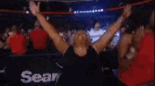 a group of people are dancing in front of a sear logo