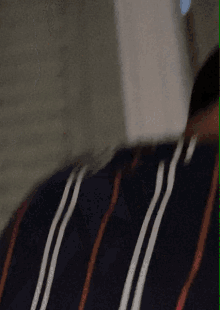 a person wearing a black and red striped shirt with white stripes
