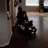 a child is sitting in a police car with a christmas tree in the back