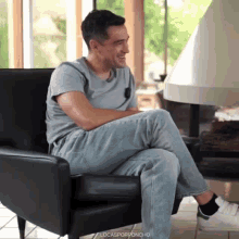 a man is sitting in a chair with his legs crossed and the words locasporponcho written below him