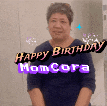 a woman is smiling in front of a happy birthday momcora sticker