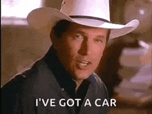 a man wearing a cowboy hat and a black shirt is talking about getting a car .