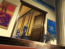 a man and a woman standing in a hallway with paintings on the wall