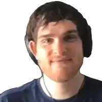 a man wearing headphones and a blue shirt is smiling for the camera