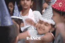a little girl is smiling in front of a sign that says time to dance on it