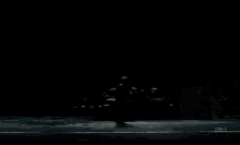 a man is playing a piano in a foggy room with tbs written on the bottom right